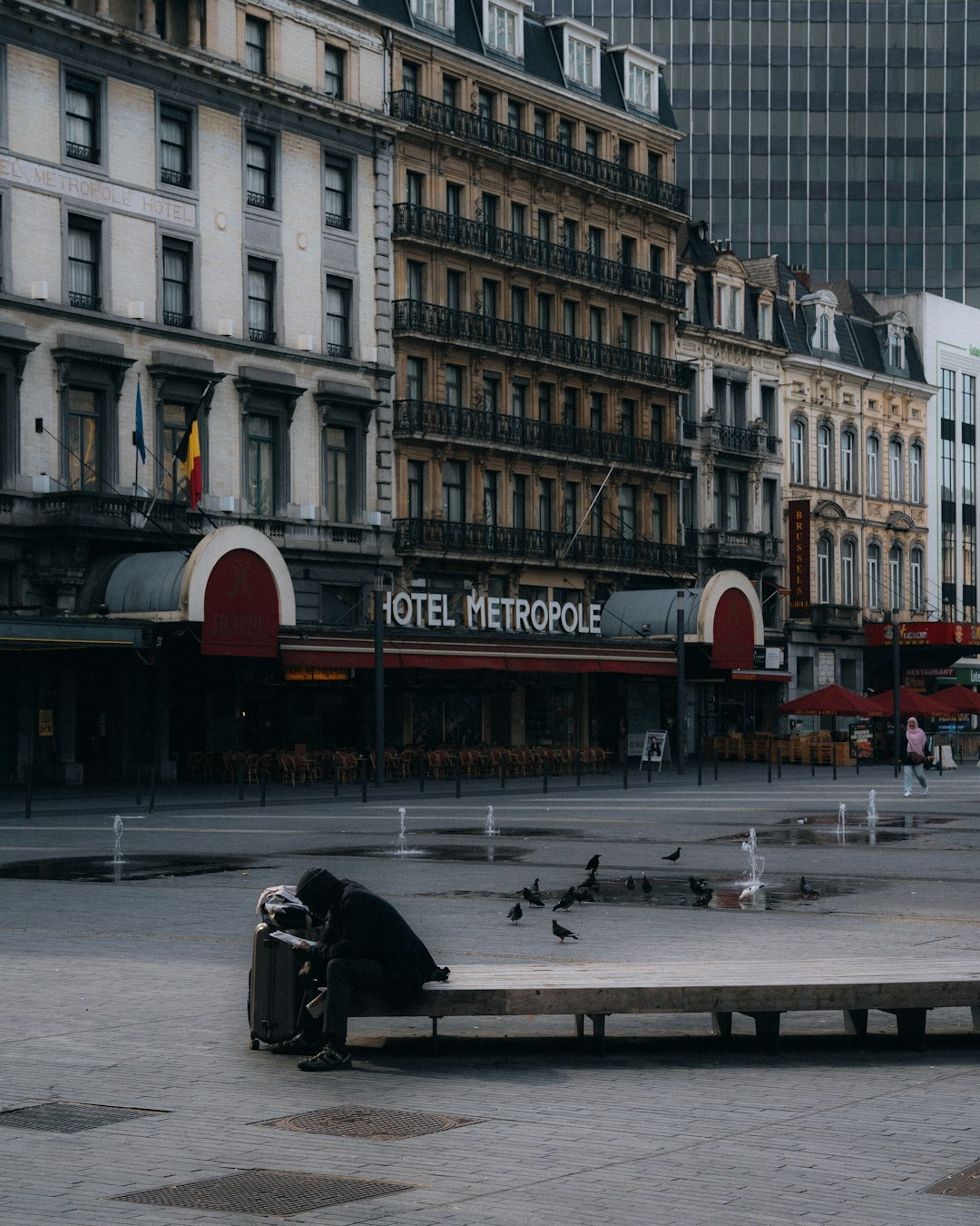 Belgian digital marketing strategist working on a laptop in an urban setting