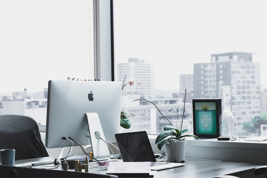 Modern office workspace with computer showing social media statistics